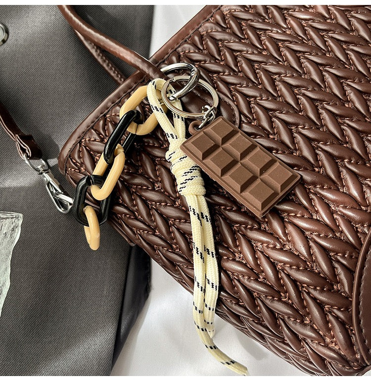 شنطة جلد مجدول بميدالية شوكولاتة-Leather Bag with Chocolate Charm
